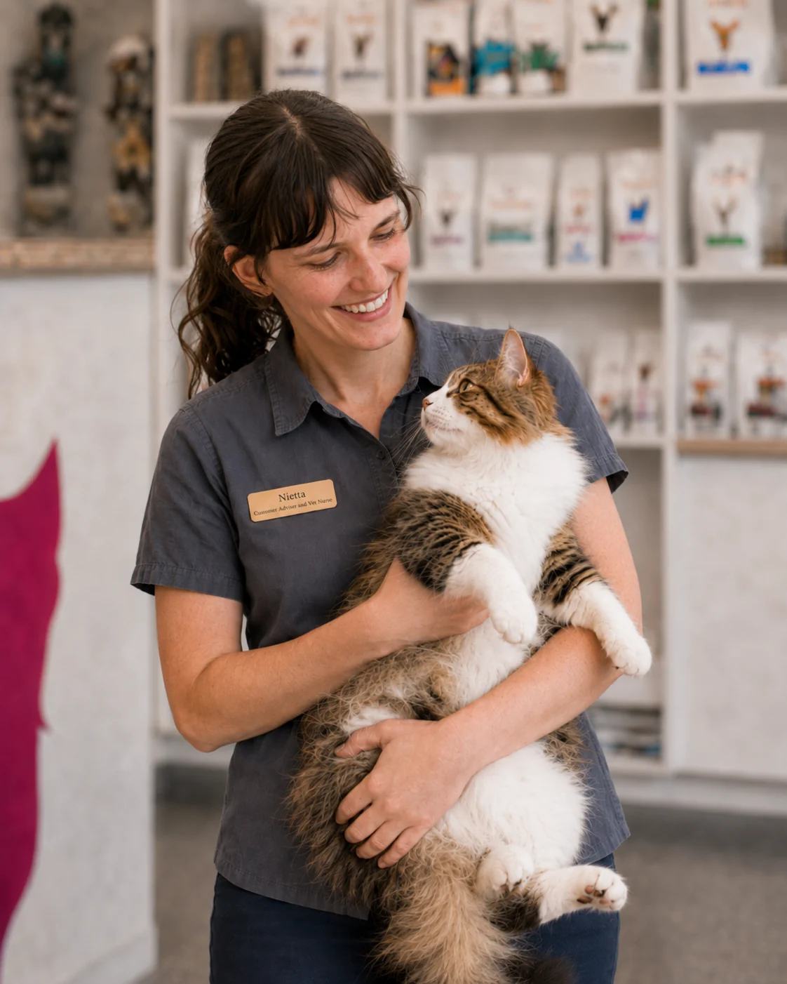 Nietta holding a relaxed cat inside The Cat Pad
